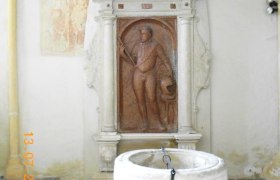 Tomb of MICHAEL TEUFEL, © Lisa Schierer Tomb with relief and baptismal font in a church.