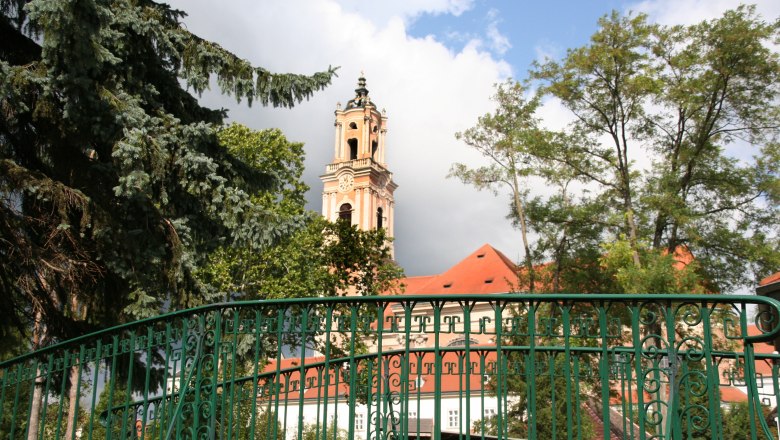 Herzogenburg Abbey, © Hans Kopitz Herzogenburg Abbey with tower and green fence in the foreground.