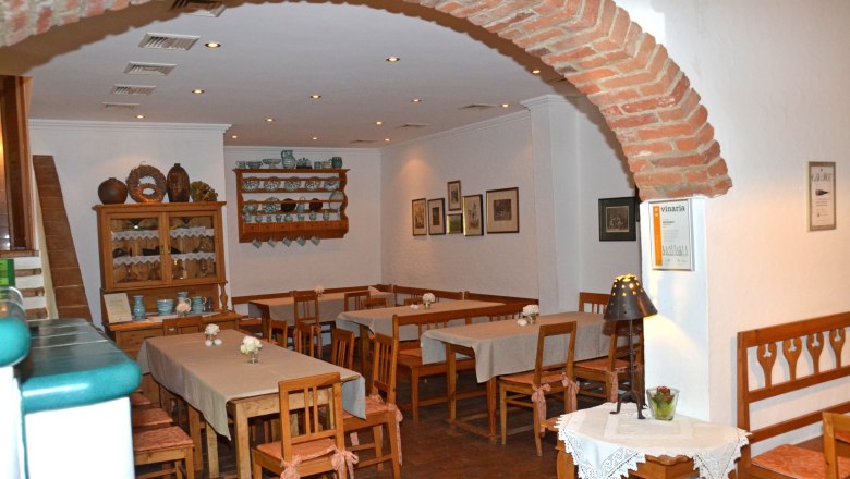 Wine tavern, © Weinstube Aichinger Cozy interior of a wine tavern with wooden furniture and decorations.