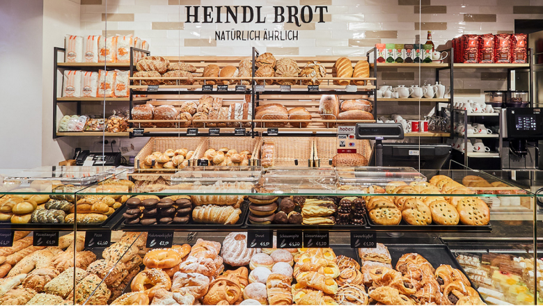 Heindl bread, © Heindlbrot Bakery with various breads and pastries on shelves and in display cases.