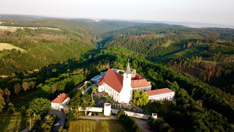 Pernegg Monastery, © © Thomas Fröhlich Aerial view of Pernegg Monastery surrounded by forest landscape.