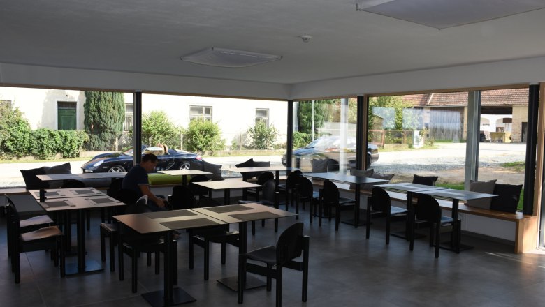 Breakfast room, © Helmut Leonhartsberger Large breakfast room with fully glazed wall and plenty of seating.