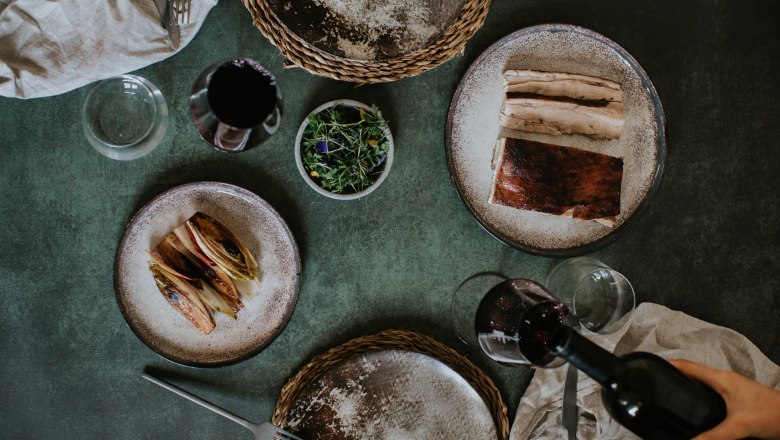 FranzvonGrün, © Franz von Grün Plate with food, wine bottle and wine glass