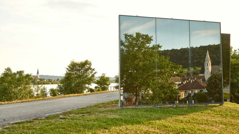 Mirror sculpture, © Klaus Engelmayer Mirror sculpture reflects landscape with church and houses.