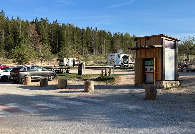 parking-place-nature-park-center-high-wall-3, © Naturpark Hohe Wand Parking lot at the Hohe Wand Nature Park Center with cars and campers, surrounded by forest.