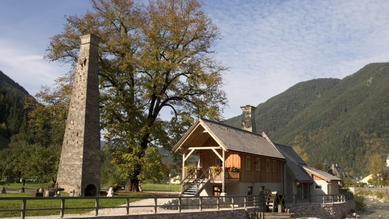 Meeting hammer, © Archiv Naturpark Eisenwurzen Historic building with chimney and water wheel in a rural setting.