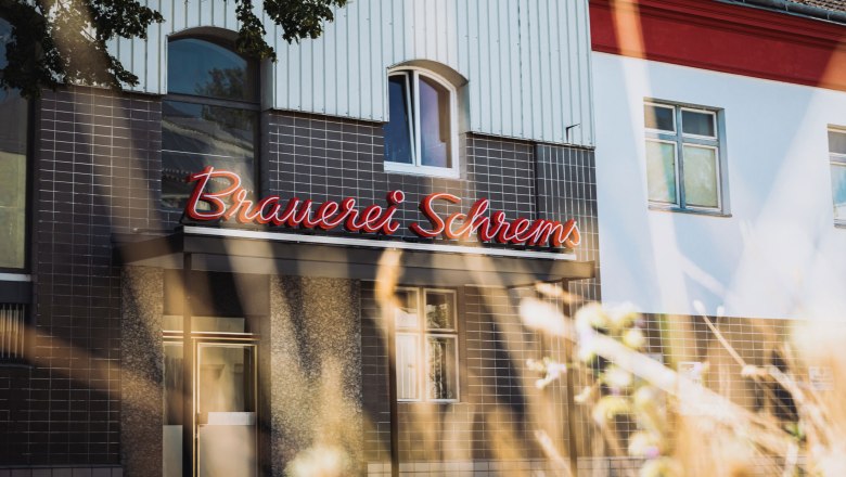 Schrems brewery, © Inge Funke Facade of the Schrems brewery with red illuminated sign.