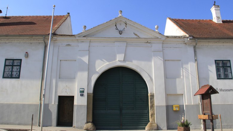 Groß Schweinbarth, © Gemeinde Groß Schweinbarth Historic building with a large gate and deer antlers on the façade.