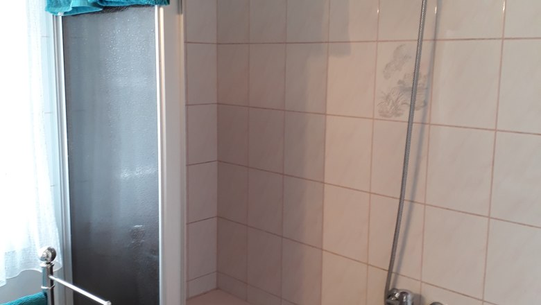 Bathroom, © Barbara Muck Bathroom with bathtub, shower curtain and blue towels.