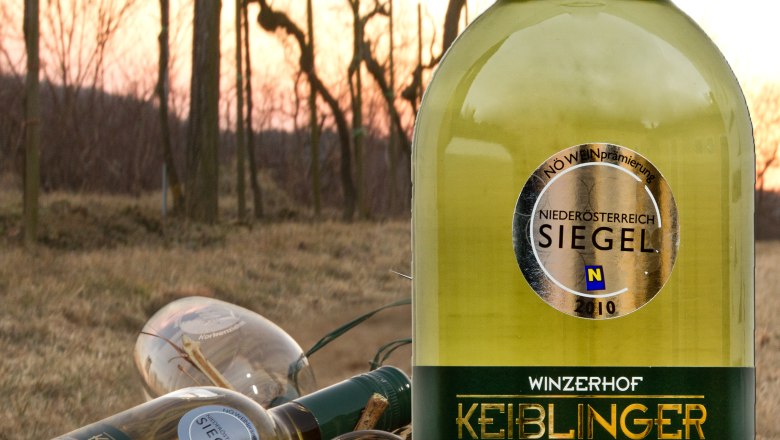 Keiblinger wine, © Winzerhof Keiblinger Keiblinger wine bottle in the foreground, vineyards in the background.