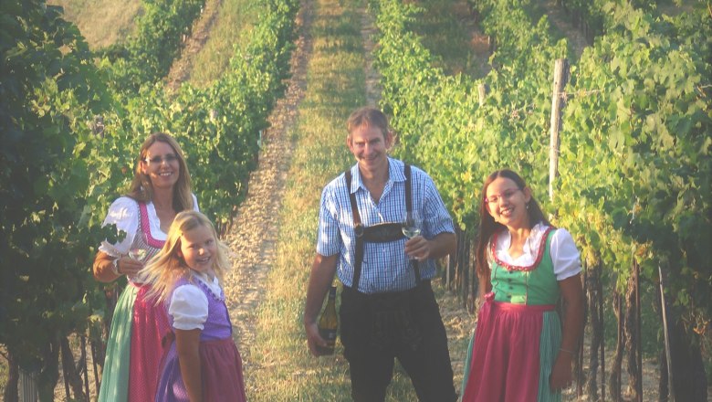 Schmid family, © Weinbau Peter Schmid Family in traditional dress in a vineyard.