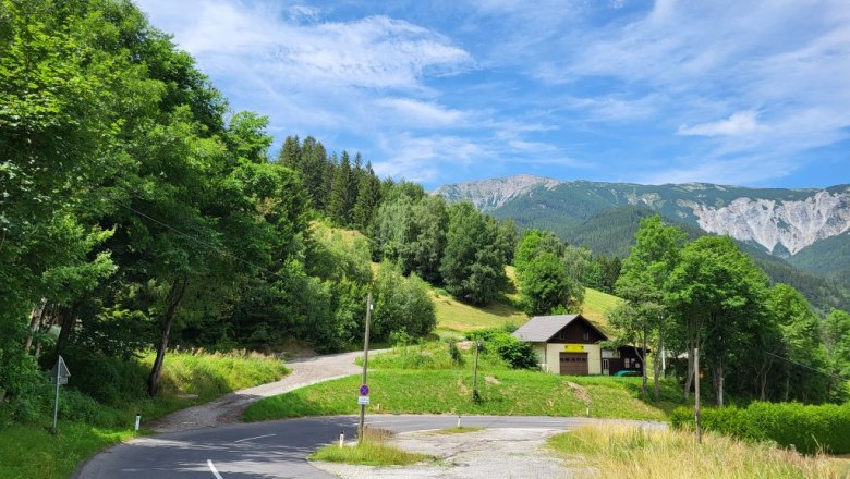 Access from Preiner Gscheid-Straße, © Villa to go Landscape with road, house and mountains in the background.