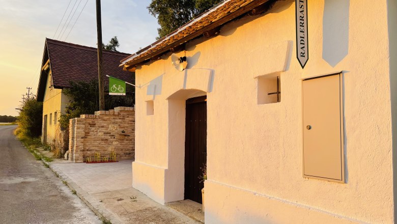Cellar outside, © Fam. Thürr Exterior view of a cellar with sign 'Radlerrast' at sunset.
