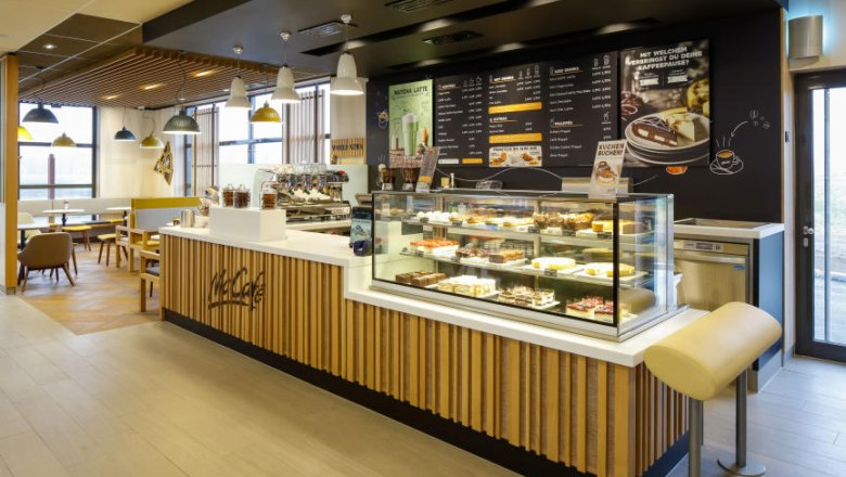 McDonalds, © McDonalds Interior view of a McCafé with counter and seating area.