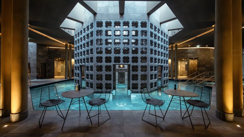 Therme Laa | Hotel | Silent Spa | Villas, © Niederösterreich Werbung / Maximilian Pawlikowsky Interior view of a modern spa with pool, tables and chairs.