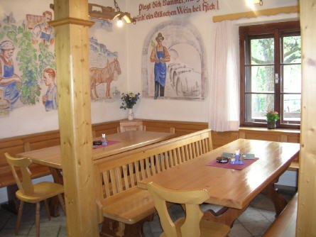 Wine bar at the Maria Hick winery, © Maria Hick Cozy wine bar with wooden furniture and murals.