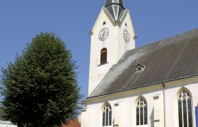 St. Laurenz parish church, © Ing. Alfred Pohl St. Laurenz parish church with tower and clock against a blue sky.