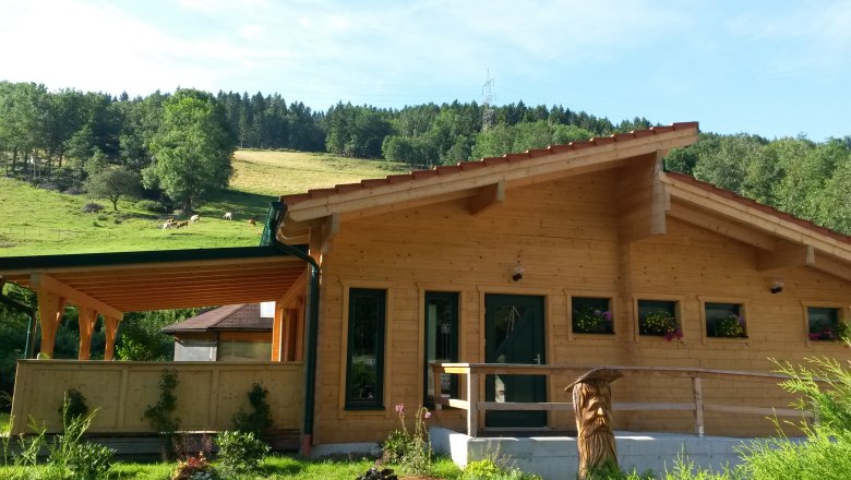 Log cabin sauna, © Familie Mies Log cabin sauna in a rural setting with wooden veranda and flower boxes.