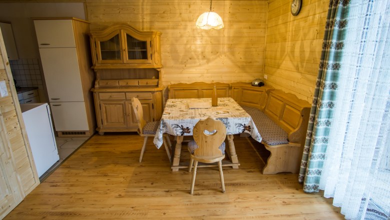 Vacation home "Romantic" Dining area, © Familie Morgenbesser Dining area in a rustic vacation home with wooden furniture and corner bench.