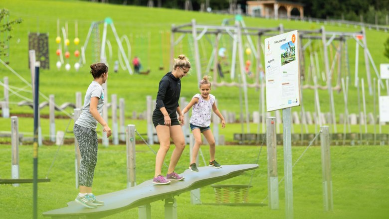 St. Corona motor skills park, © Wexl Arena St. Corona am Wechsel Three people balancing on a seesaw in the St. Corona motor skills park.