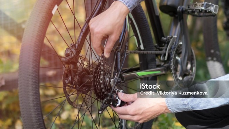Wheel repair, © i stockphoto, Aleksandr Potashev Person repairs bicycle chain outdoors.
