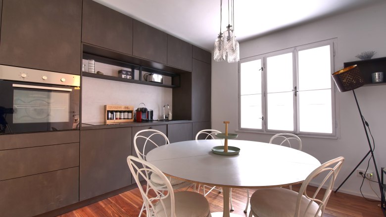 Kitchen Top 3, © Daniela Sinadinoska Modern kitchen with dining table, chairs and hanging lamp.