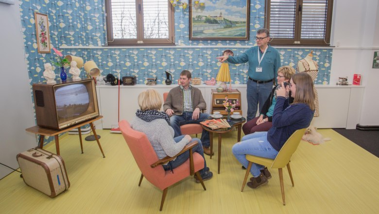 60s living room, © Franz Engl Group of people in a 60's style living room with retro furniture and decoration.