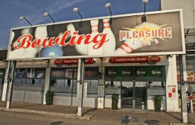Pleasureland Bowling, © Wiener Alpen/Katrin Zeleny Entrance to a bowling center with a large sign 'Bowling Pleasureland'.