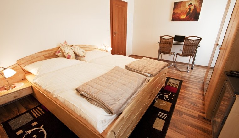 Double room, © Pension Theresa A cozy double room with wooden floor, double bed, desk and chairs.