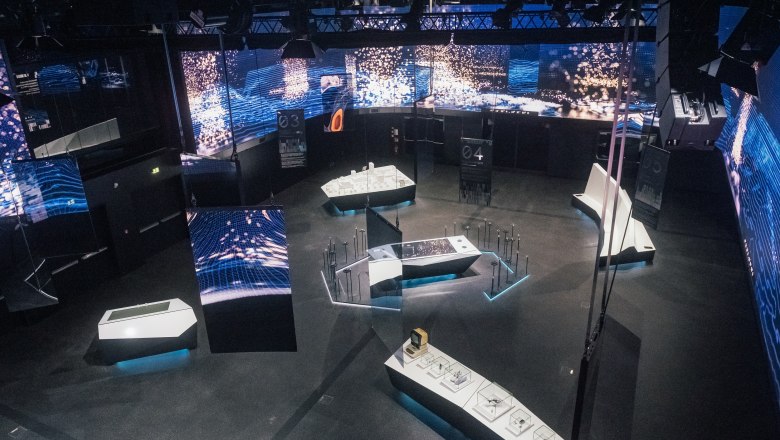 TD House of Digitization, © Leonardo Ramirez Exhibition room with a large flat screen on the wall and several tables as part of the exhibition