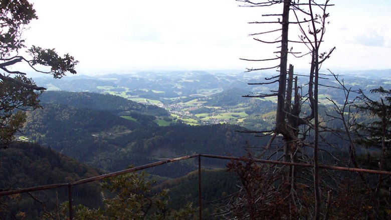 Castle stone wall, © Bertel Inge View from a mountain with railings and trees in the foreground, view of hilly landscape.
