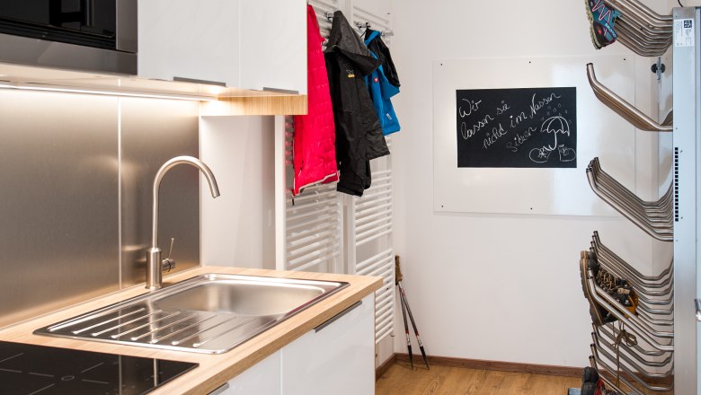 Suite, © Martina Siebenhandl Modern kitchen with sink, microwave, jackets on hooks and ski boot dryer.