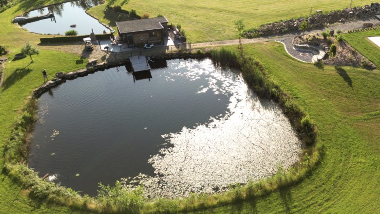Ponds from above, © Familie Moser Aerial view of two ponds with surrounding grassland and a small building on the shore.
