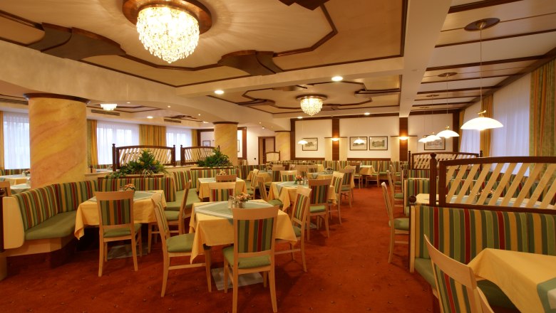 Hall in the Hotel Thier, © Franz Thier Elegant dining room with chandeliers and striped upholstered furniture.