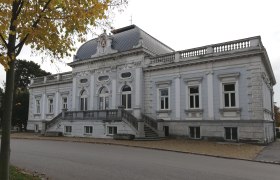 The Korneuburg City Museum in the fall, © Melanie Lopin Exterior view of the Korneuburg City Museum in fall with yellow leaves in the foreground.