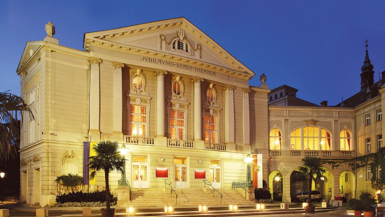 Baden Municipal Theater, © Christian Husar The Stadttheater Baden at night, illuminated with warm light.