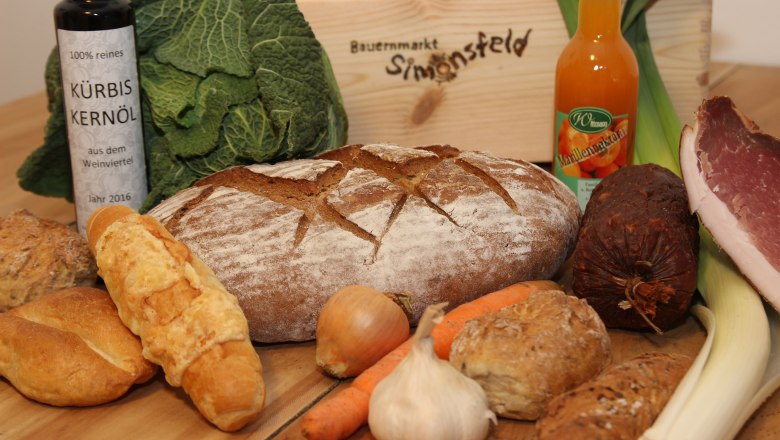 Colorful assortment, © Josef Popp Various foods such as bread, vegetables, oil and sausage on a table.