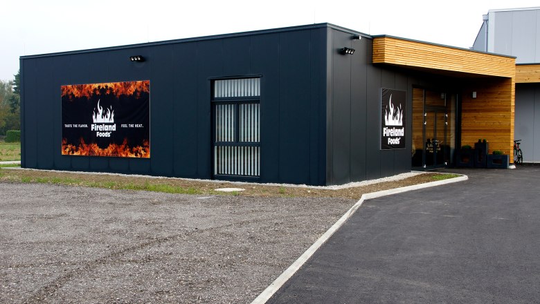 Exterior view of Fireland Foods, © zVg Exterior view of a modern building with Fireland Foods logo and slogan.