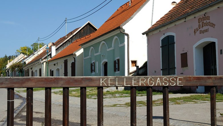 Grafenwörth wine cellar lane, © Josef Stefan Historic wine cellar lane in Grafenwörth with colorful buildings and a wooden fence in the foreground.