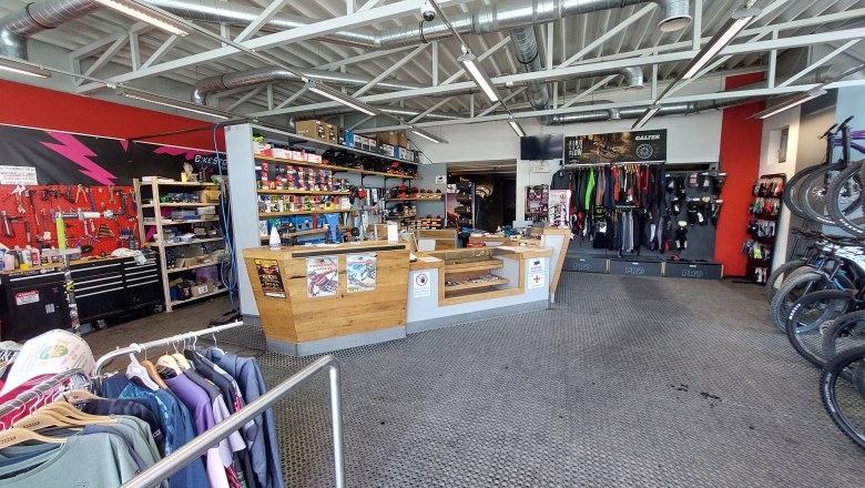 Bikestore.cc, © Bikestore.cc Interior view of a bicycle store with workshop area, sales counter and bicycle accessories.