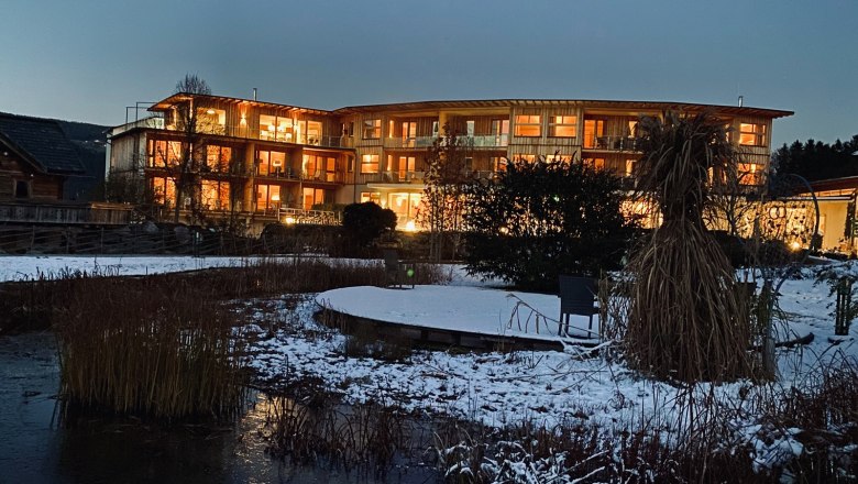 Molzbachhof by night, © Peter Pichler Illuminated building at night with a snow-covered garden in the foreground.