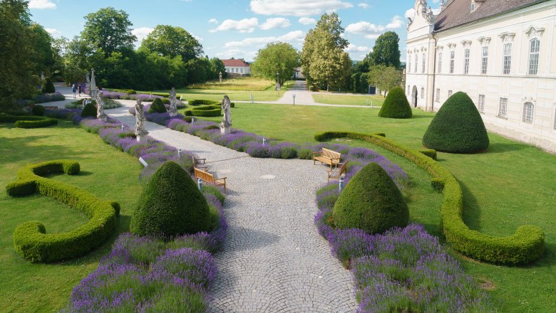 Altenburg Abbey, © Martina Draper Gardens with lavender and statues in front of a historic building.