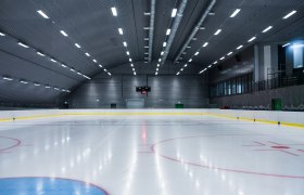 Ice rink, © Leithana Empty ice rink with illuminated pitch and scoreboard.