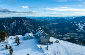 Drone pictures Raxalm-Berggasthof, © KS Content & Marketing Aerial view of the Raxalm mountain inn in winter with snow-covered mountains and valleys in the background.