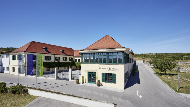 Winegrower Krems, © Helge Kirchberger Winzer Krems building with red roofs and blue sky.