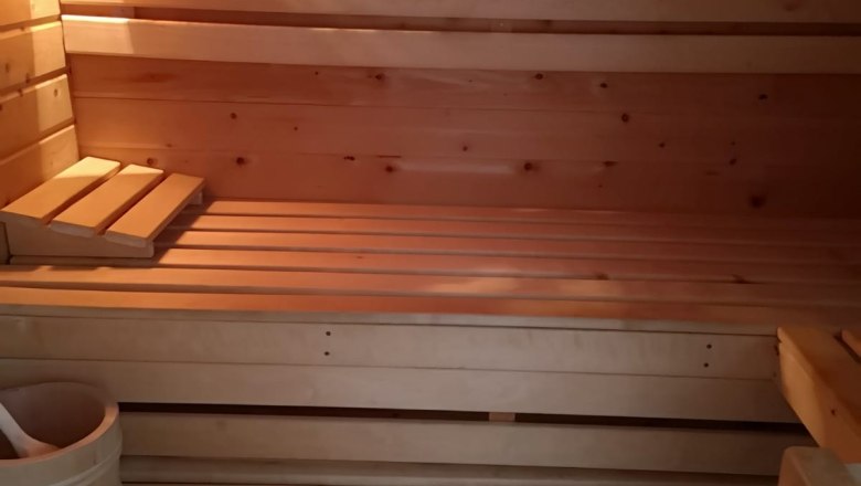 Sauna, © Haselberger Interior view of a wooden sauna with benches, thermometer and bucket.