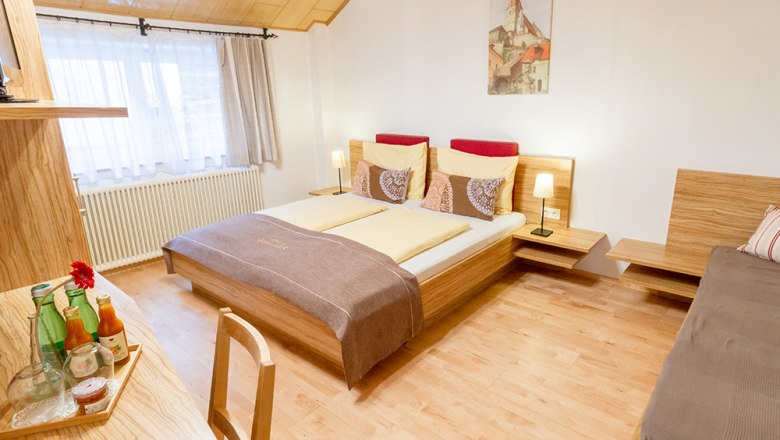 Guest room, © Annemarie Heller Cozy guest room with double bed, wooden furniture and decoration.