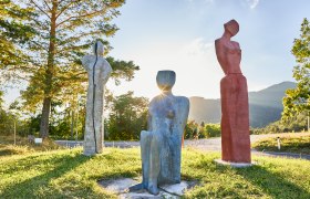 Good gas part, © Nina Nagy Photography Three colorful sculptures on a meadow at sunset.