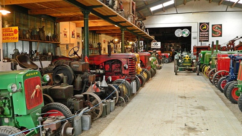 Tractor museum3, © Martin Andrä Interior view of a tractor museum with old tractors and advertising signs.