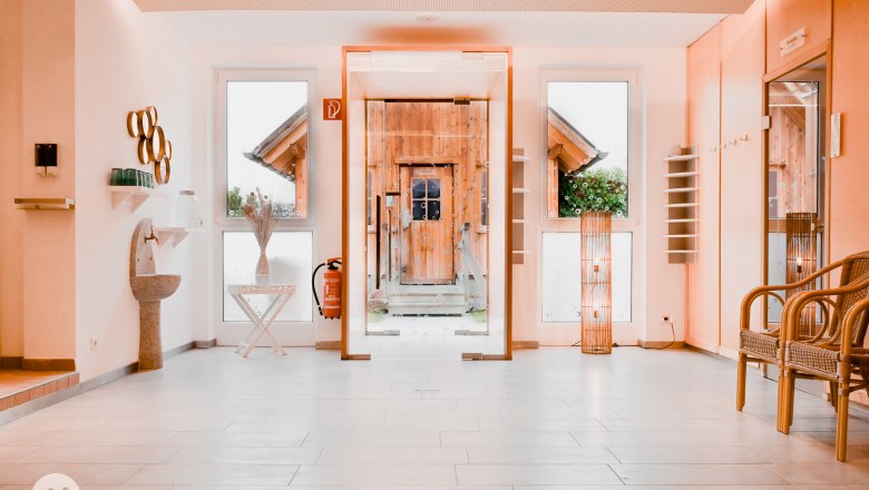 Lounge area, © TheVerve-Agentur (theverve.at) Modern lounge area with glass wall, wooden door, decorations and seating.